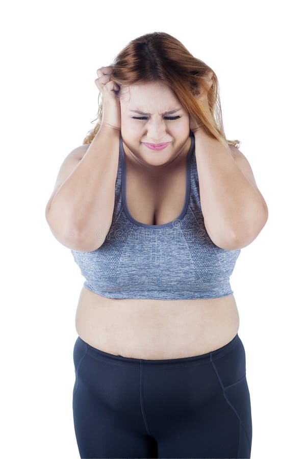 Frustrated overweight woman in studio royalty free stock photo Frustrated overweight woman in studio royalty free stock photo