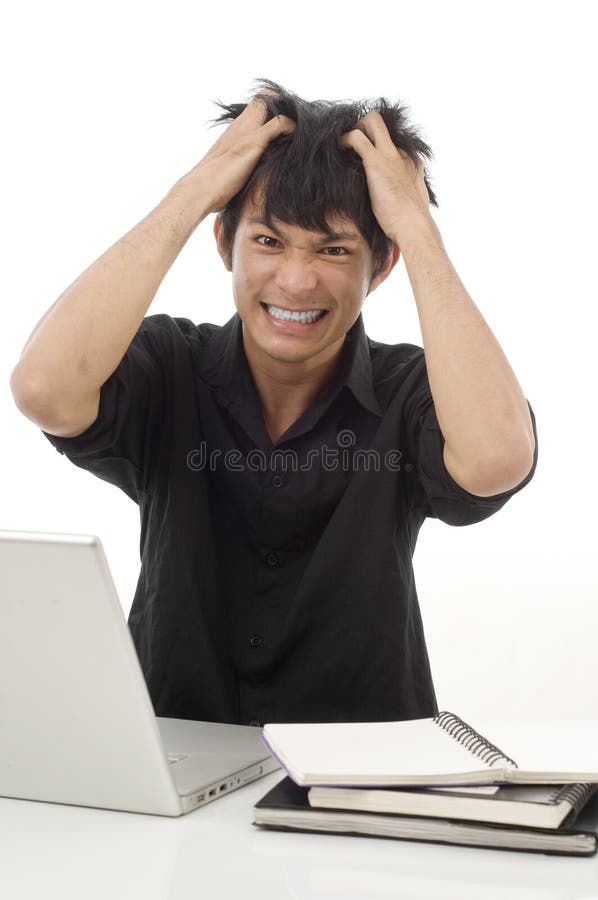 Asian teenage student pulling his hair out from frustration. Asian teenage student pulling his hair out from frustration