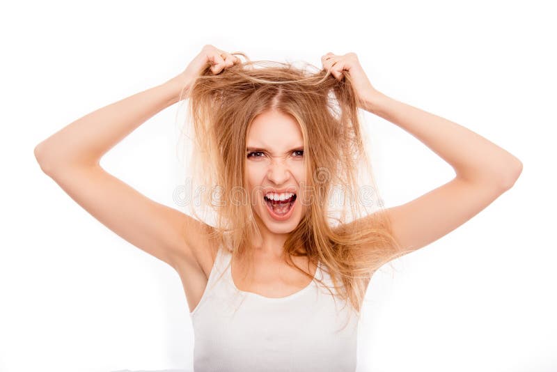 Frustrated young blonde holding her damaged hair and yelling stock photos Frustrated young blonde holding her damaged hair and yelling stock photos