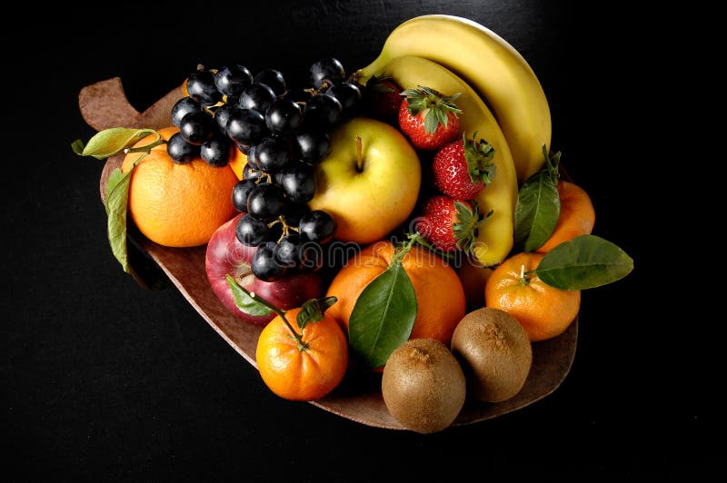 Fruits composition with orange, grape fruit, apple, strawberry, banana and kiwi on black background. Fruits composition with orange, grape fruit, apple, strawberry, banana and kiwi on black background