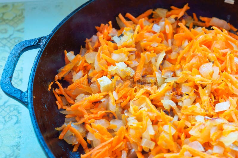 Fry the Grated Carrots and Onions in a Pan, Cook the Roast Onions and Carrots Stock Image