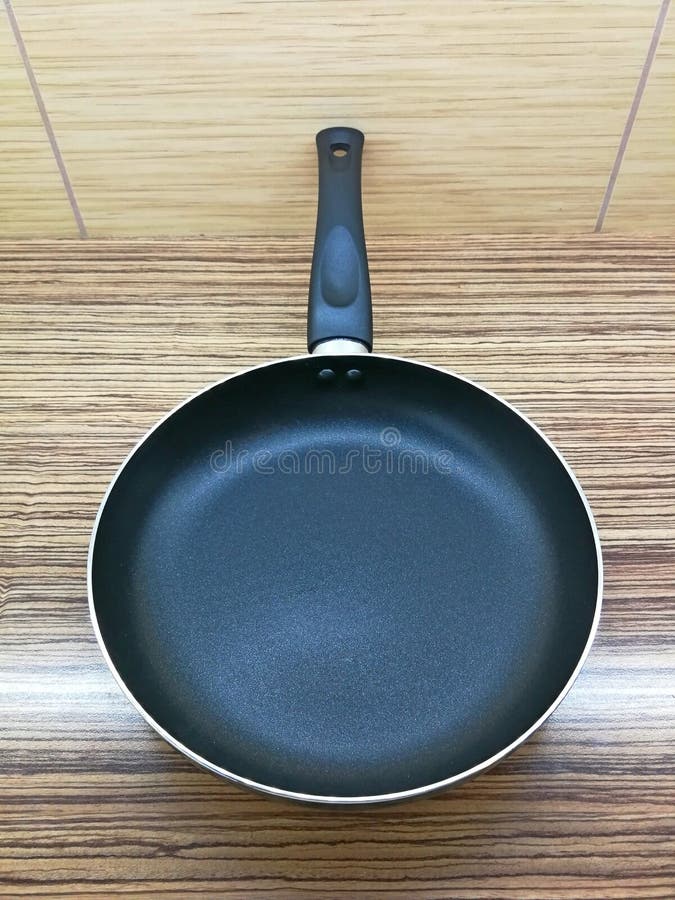 Frying Pan with Black Surface and Black Plastic Handle Stock Image