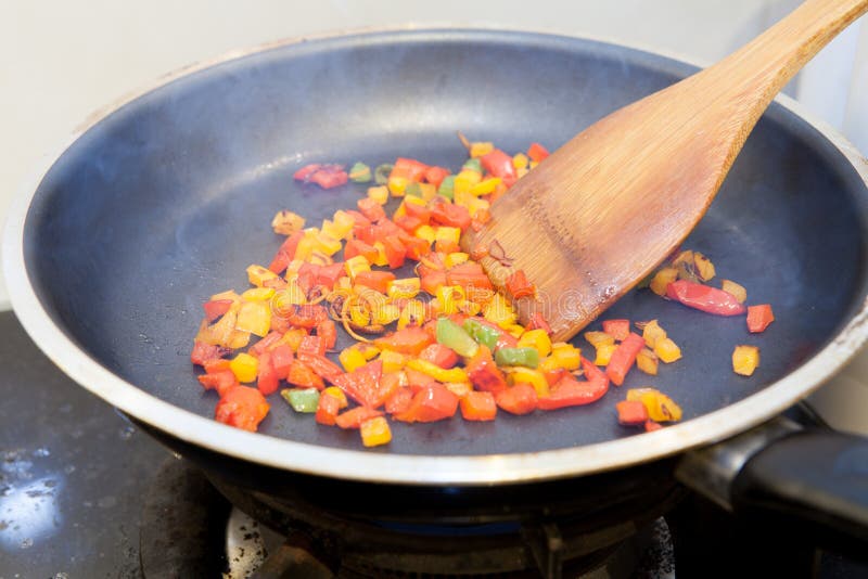 Frying Pan with Chopped Bell Pepper and Spices on Gas Stove Stock Image