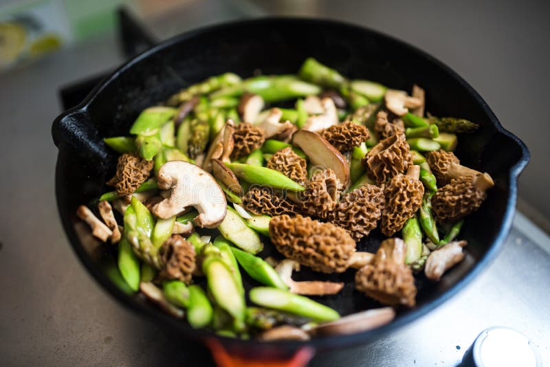 Frying pan full of morels and asparagus