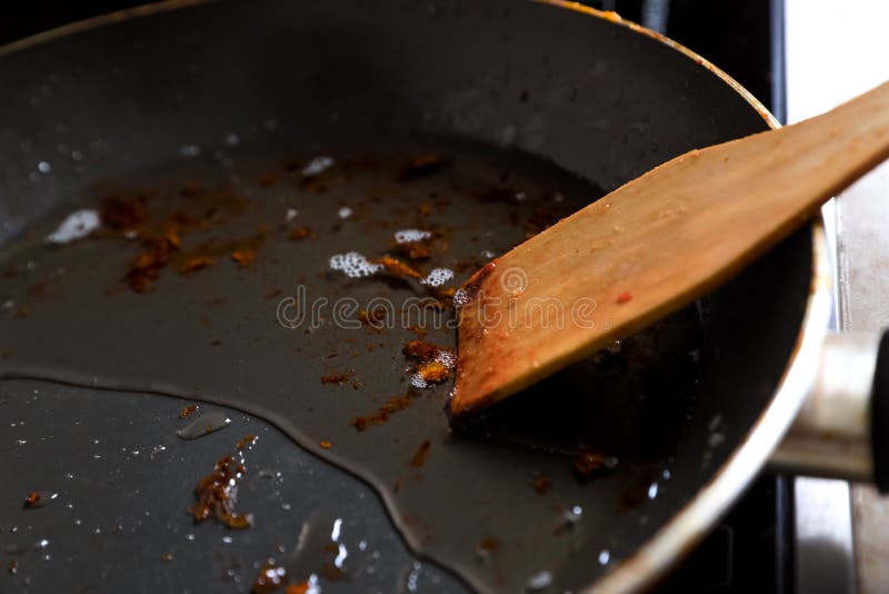 Frying Pan with Spatula and Used Cooking Oil on Stove, Closeup Stock ...