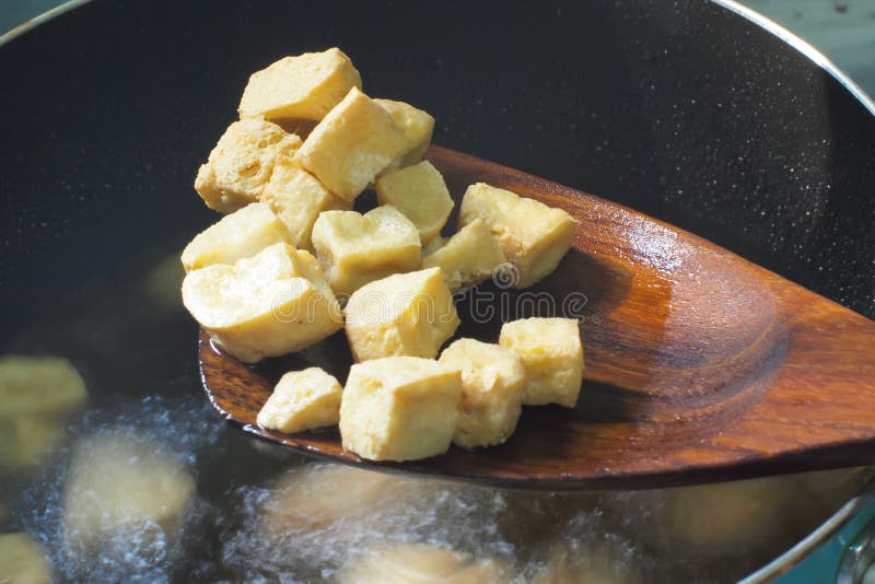 Frying tofu with hot oil stock image. Image of fried 30530073