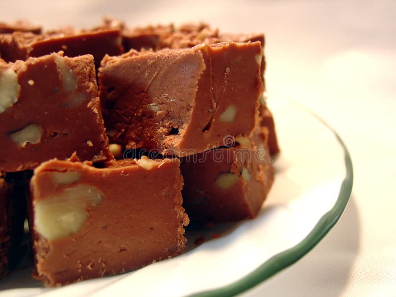Chocolate fudge with walnuts on a plate. Chocolate fudge with walnuts on a plate