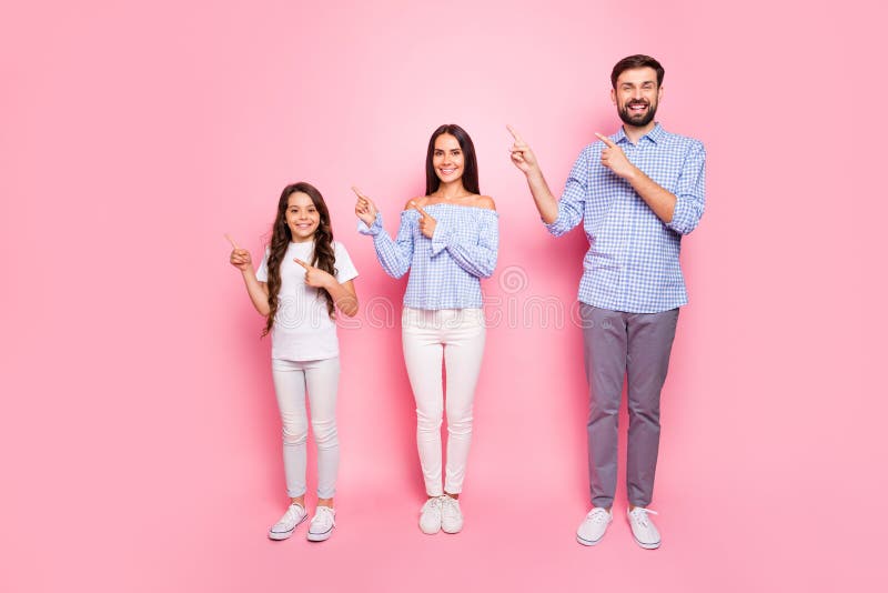 Full body photo of charming family with long wavy curly haircut pointing at copy space wearing checkered shirt trousers stock photos Full body photo of charming family with long wavy curly haircut pointing at copy space wearing checkered shirt trousers stock photos