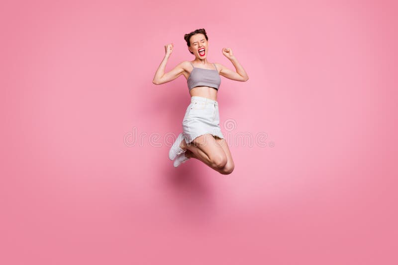 Full body photo of delighted positive girl jump win lottery have discounts news scream yeah yes raise fists feel rejoice