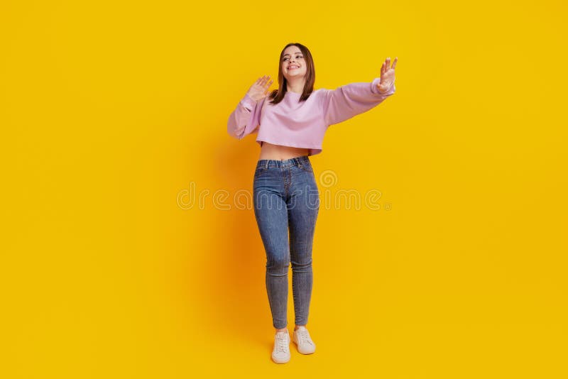 Full body photo of young attractive girl wear casual outfit dance show hand no sign isolated over yellow color royalty free stock images