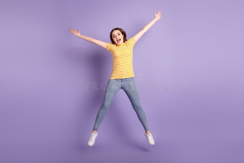 Full body photo of young cheerful girl have fun jumper fly active isolated over purple color background royalty free stock photography