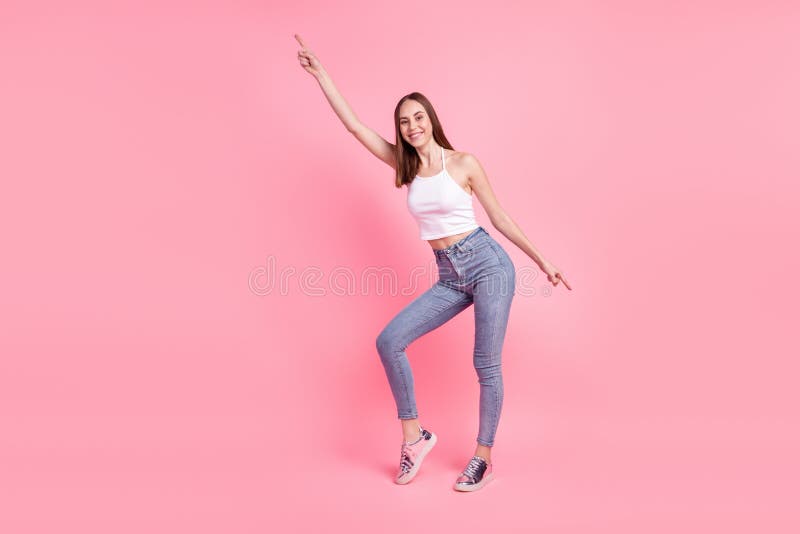 Full body photo of young cheerful girl indicate fingers empty space modern clothes  over pink color background royalty free stock photos