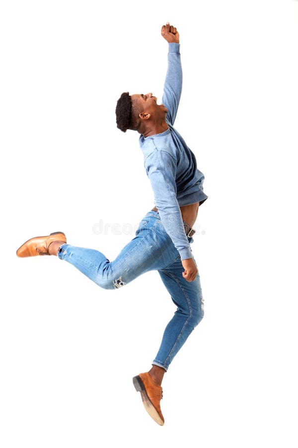 Full body profile of happy young black man jumping for joy against isolated white background