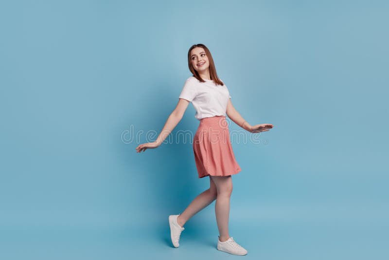 Full body profile side photo of young cheerful girl good mood go walk look empty space  over blue color royalty free stock photos