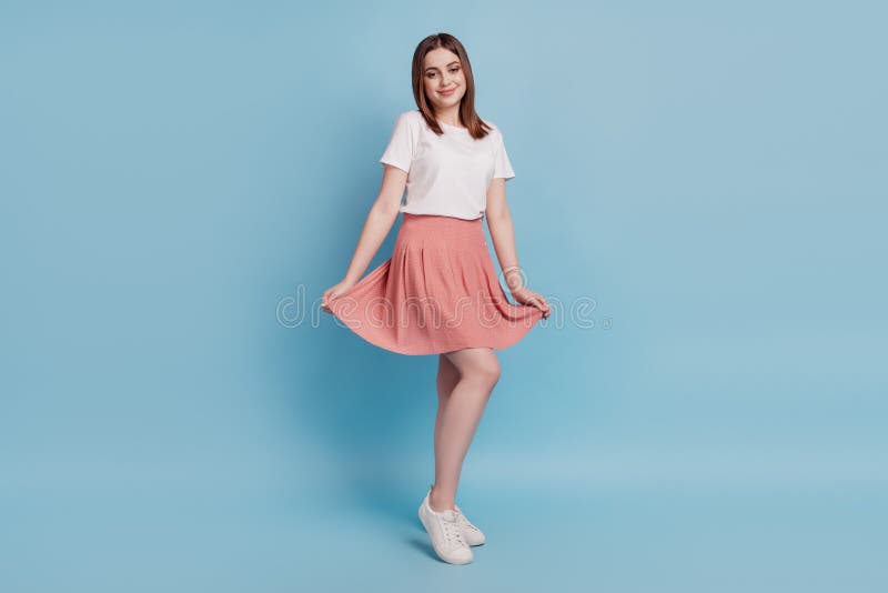 Full body profile side photo of young cheerful girl wear skirt good mood  over blue color background royalty free stock image