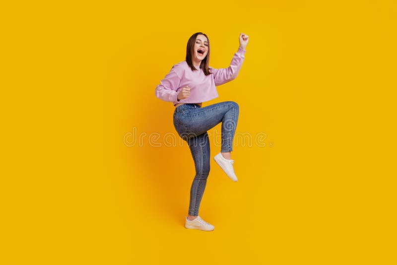 Full body profile side photo of young excited girl celebrate win lottery isolated over yellow color background royalty free stock photography