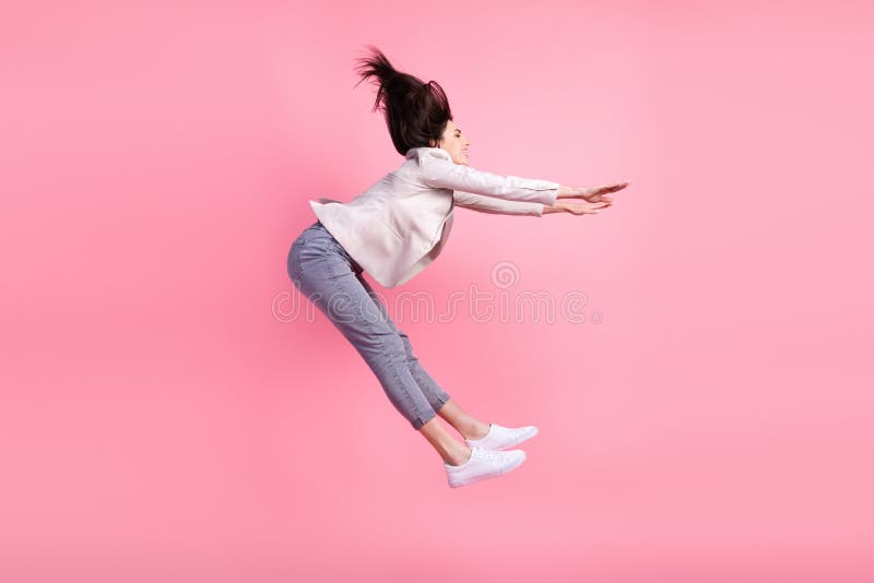 Full body profile side photo of young excited girl jump fly catch look empty space  over pastel color background stock photography
