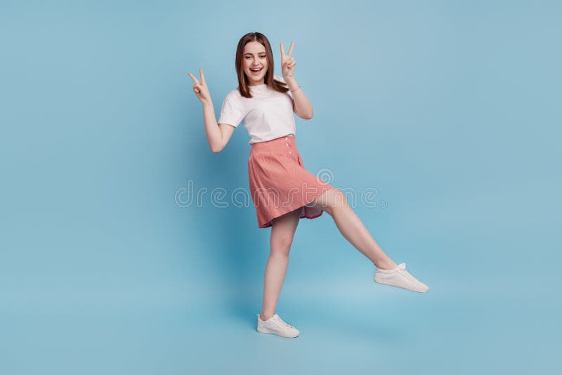 Full body profile side photo of young girl show peace cool v-sign go walk  over blue color background royalty free stock image