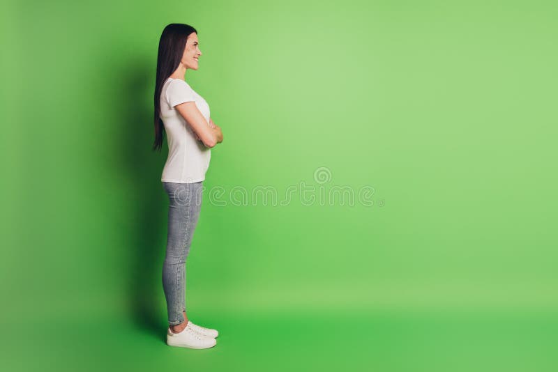 Full body profile view portrait of confident lady look copyspace isolated green color background royalty free stock photos