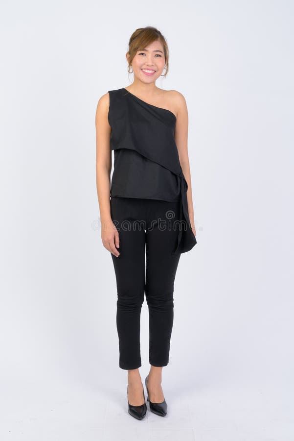 Full body shot of young happy Asian businesswoman smiling stock photography Full body shot of young happy Asian businesswoman smiling stock photography