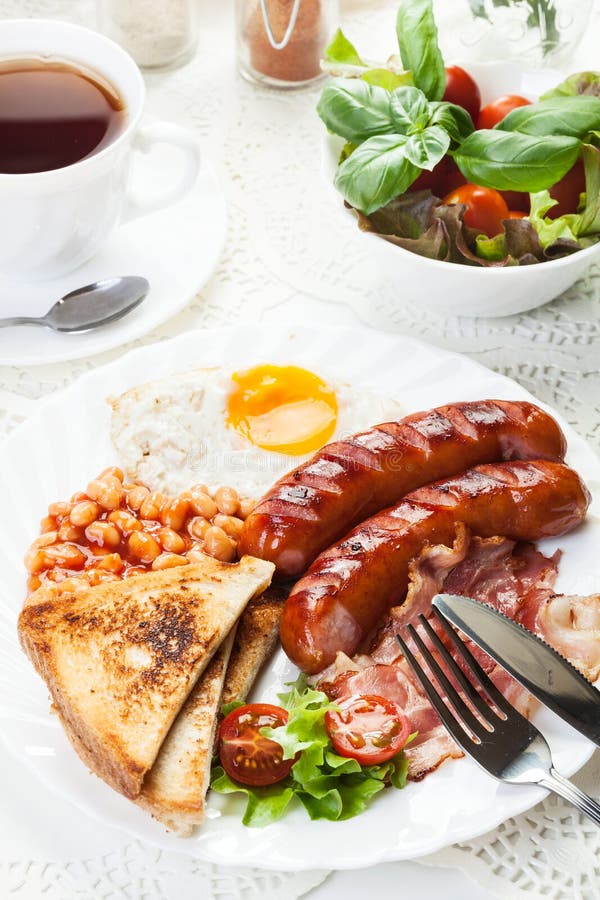 Full English Breakfast with Bacon, Sausage, Fried Egg and Baked Beans Stock Image Image of