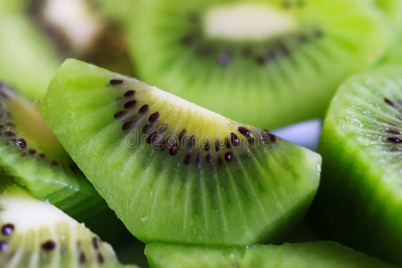 Full frame macro close up of sliced fresh green shiny kiwi fruits stock images Full frame macro close up of sliced fresh green shiny kiwi fruits stock images