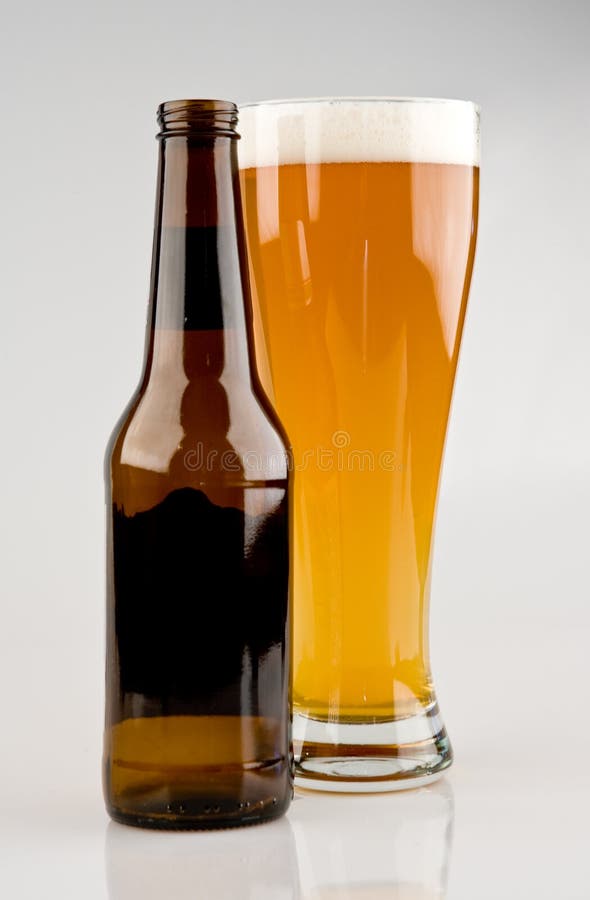 Full Glass of Light Beer with Bottle royalty free stock photography