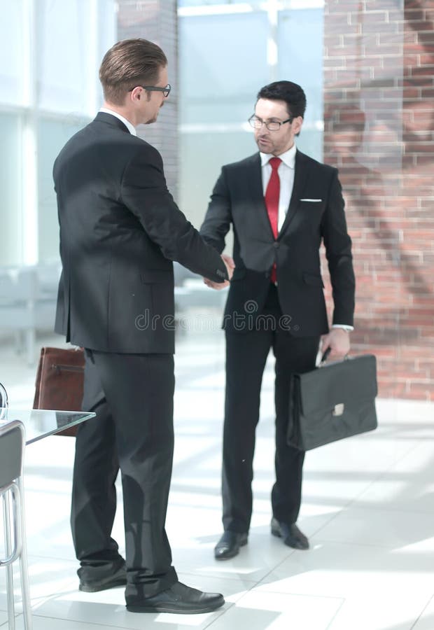 In full growth.Mature businessmen meet in a modern office . the concept of cooperation