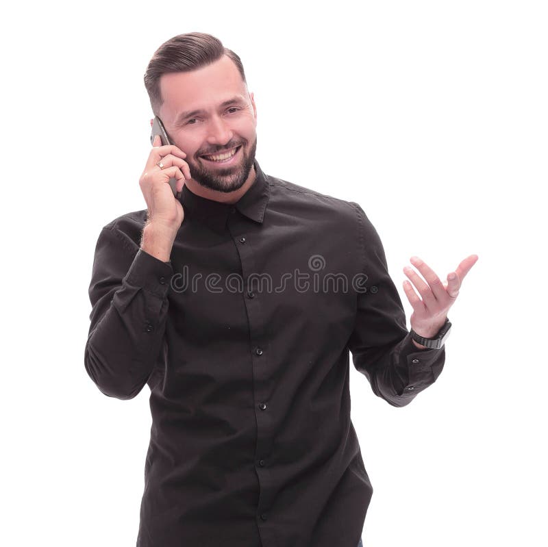 In full growth. smiling young man talking on his smartphone royalty free stock photo