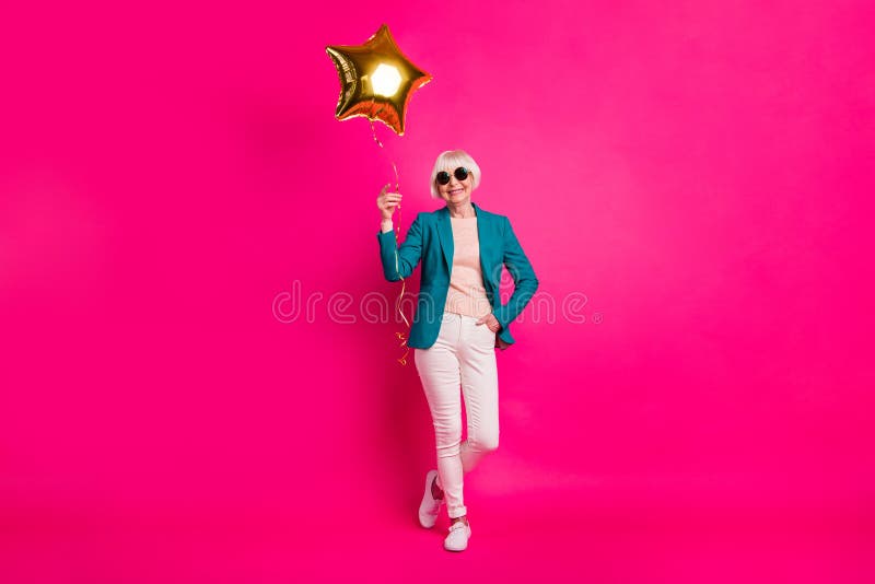 Full length body size view of nice-looking attractive well-dressed cheerful gray-haired lady holding balloon enjoying