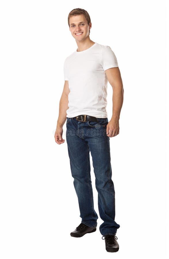 Full length of a cute young man in jeans and t-shirt looking at the camera, against white background