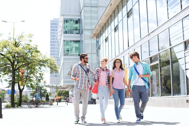 Full-length male and female friends walking on city street royalty free stock photo Full-length male and female friends walking on city street royalty free stock photo