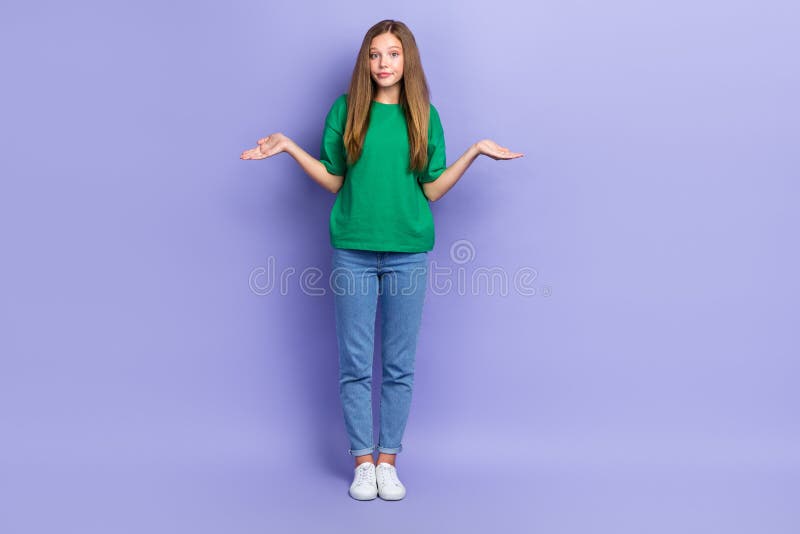 Full length photo of doubtful unsure girl dressed green t-shirt shrugging shoulders isolated purple color background