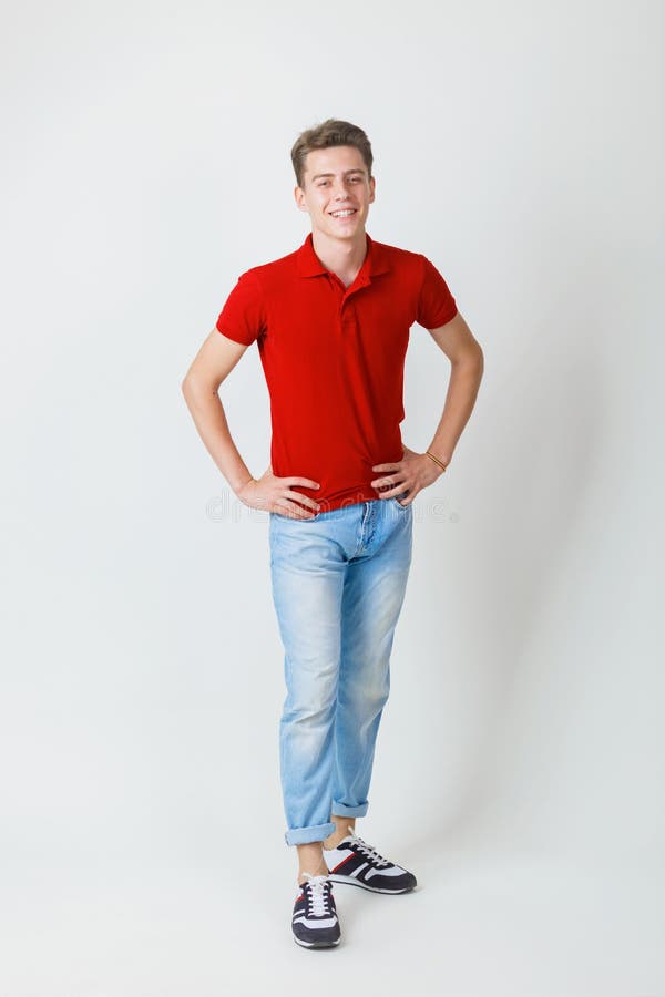 Full Length Photo of Looking Cheerful European Guy Wearing Red Shirt and Blue Smiling Standing Over White Stock Photo - Image of people, looking: 138679080