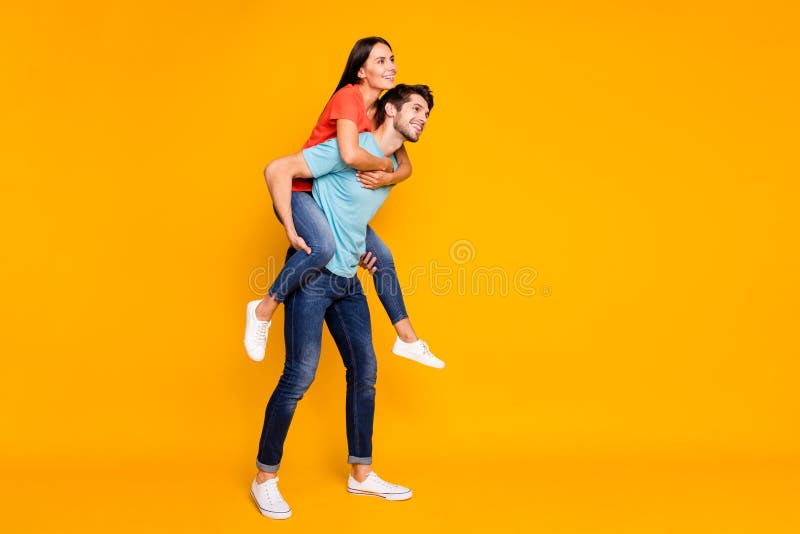 Full length photo of two funny people guy carrying lady piggyback meet summer adventures together wear casual trendy