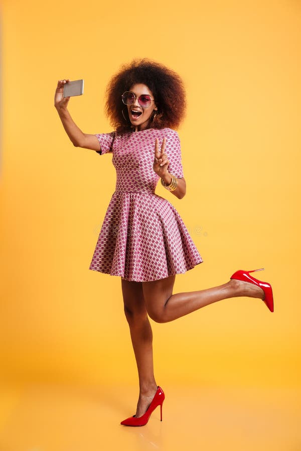 Full length portrait of a cheery afro american woman