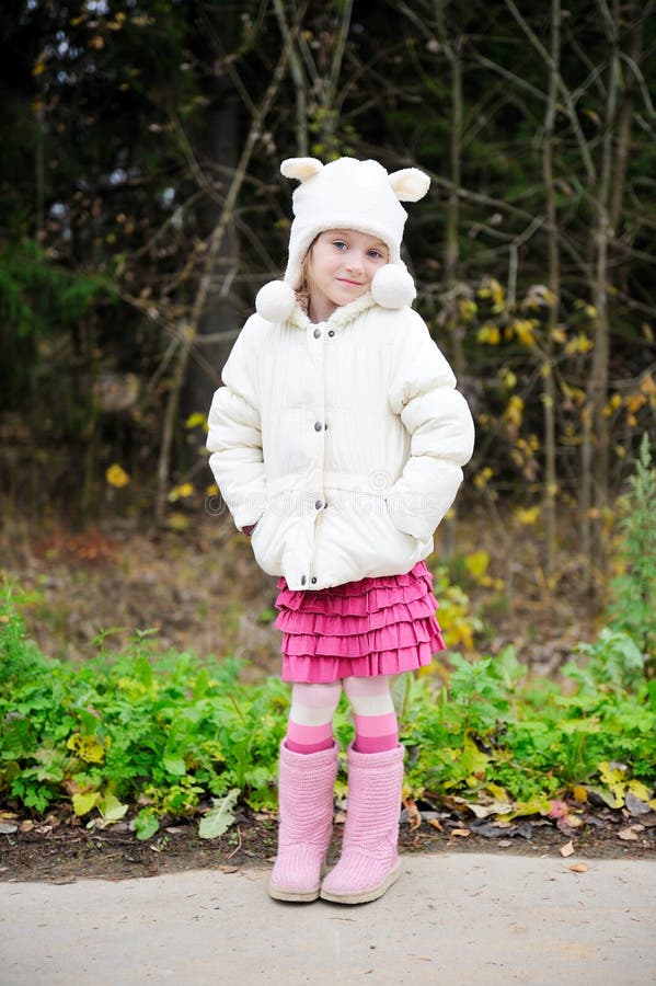 Full length portrait of a child girl in warm hat