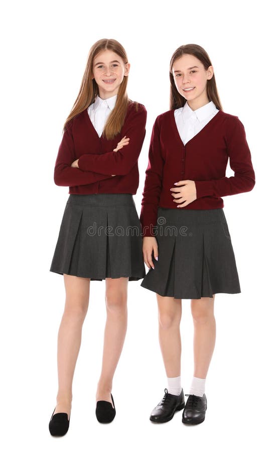 Full length portrait of teenage girls in school uniform on white