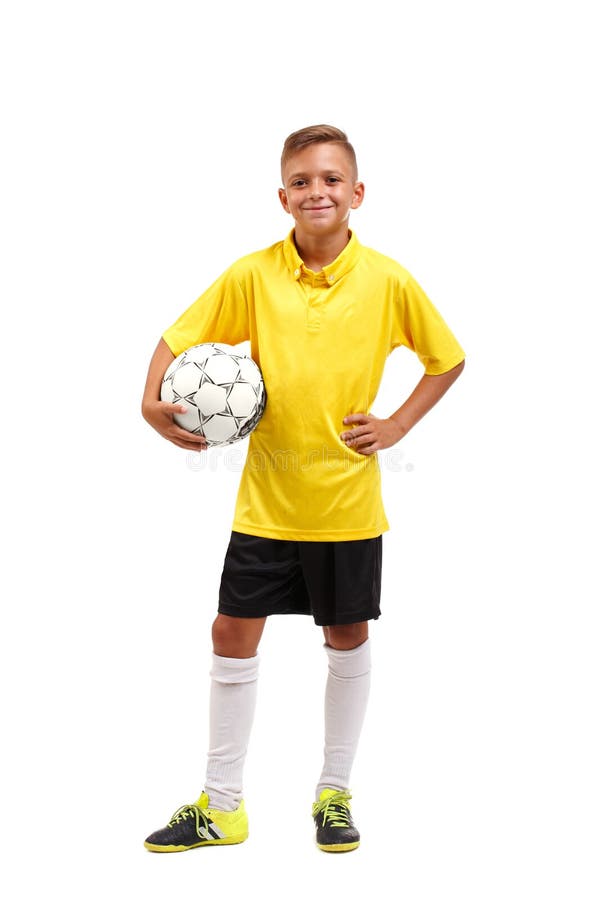 A full-length portrait of a young footballer in a yellow T-shirt holes in arms a ball isolated on a white background.