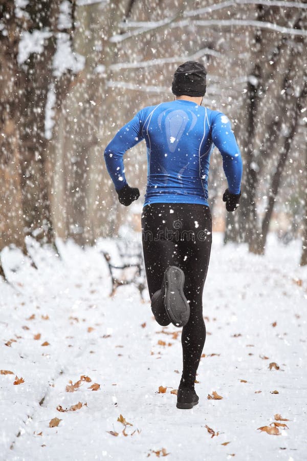 Man in Winter Sports Outfit Running on Snow in a Park Stock Photo - Image  of single, jogging: 216077330