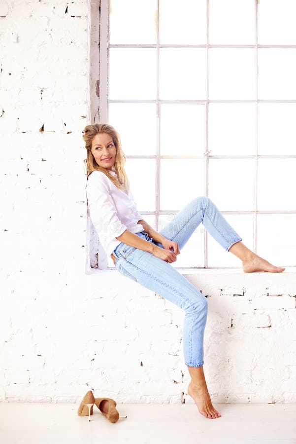 Confident Blond Woman Wearing Casual Clothes while Posing by the Window ...