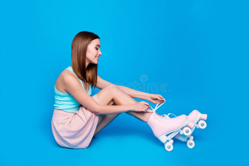 Full length side profile body size photo funny beautiful sit floor she her lady look hands tie rollers legs laces active royalty free stock photo