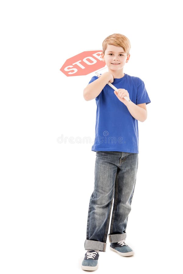 Full length view of smiling boy holding stop sign royalty free stock photos
