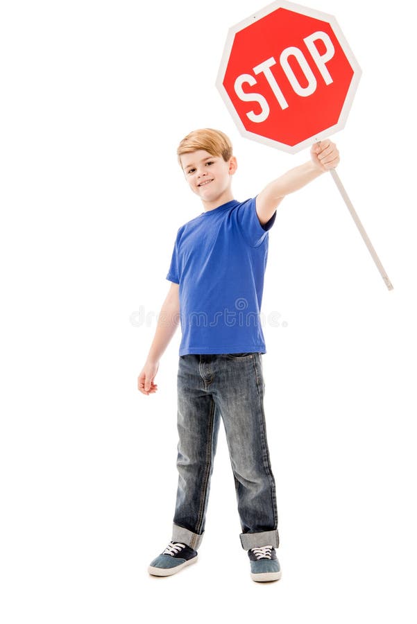 Full length view of smiling boy holding stop sign stock photos