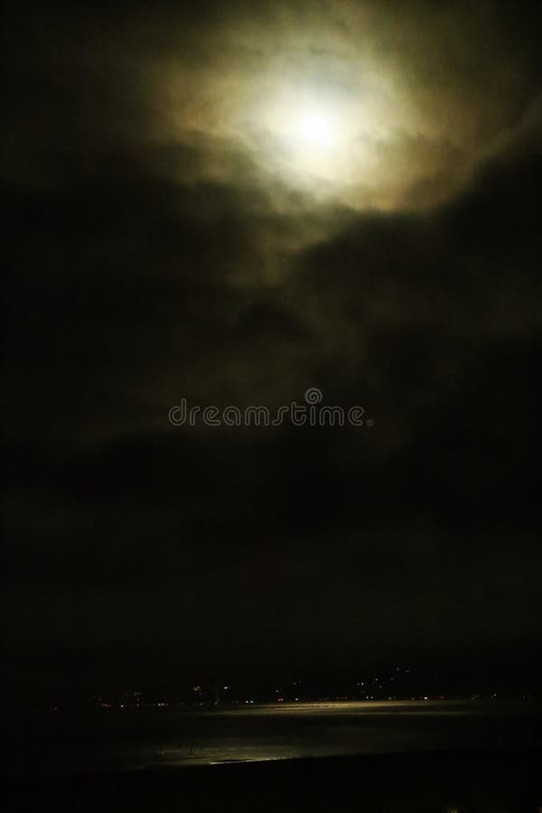 Full moon obscured by clouds stock image