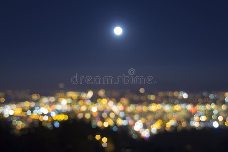 Full Moon Rise Over Blurred City Lights Landscape stock photos
