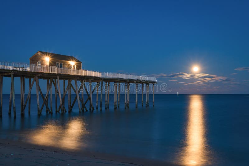 Full moon rising at a fishing pier