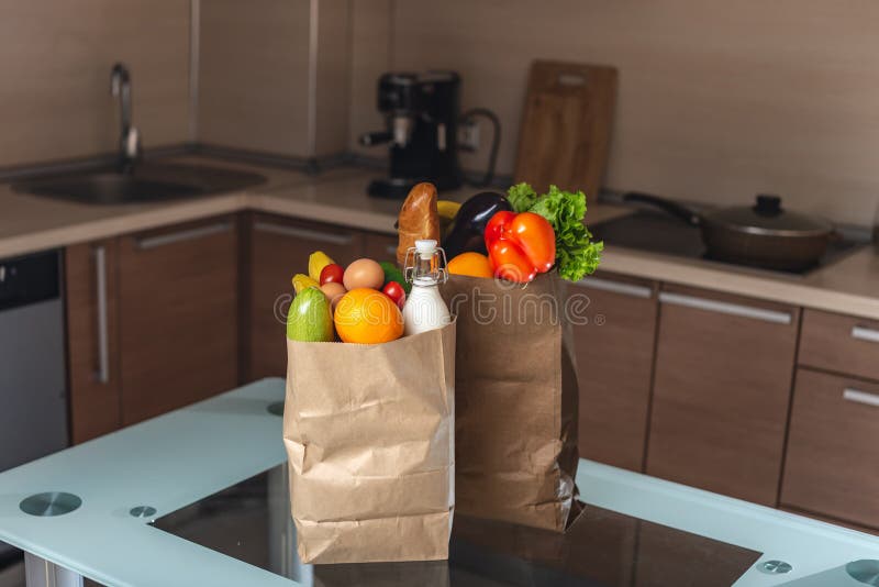 Full Paper Bags With Foods On The Table On The Background Of The