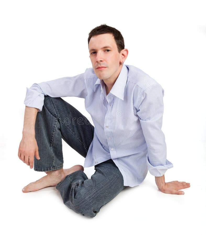 Full portrait of handsome man sitting on the floor