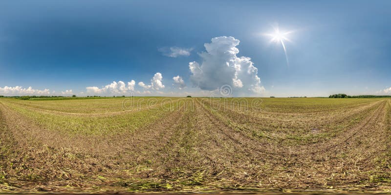 full seamless 360 hdri panorama view among farming fields with sun with huge clouds in clear sky in equirectangular spherical